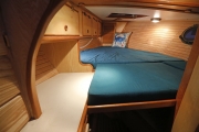 Forward cabin set up as double bed. Anchor chain locker in forepeak.